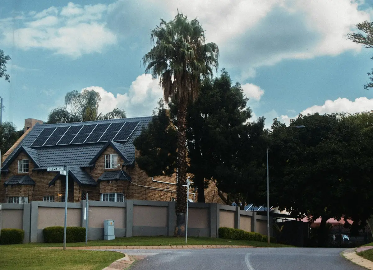 Florida-style home with rooftop solar panels and palm trees
